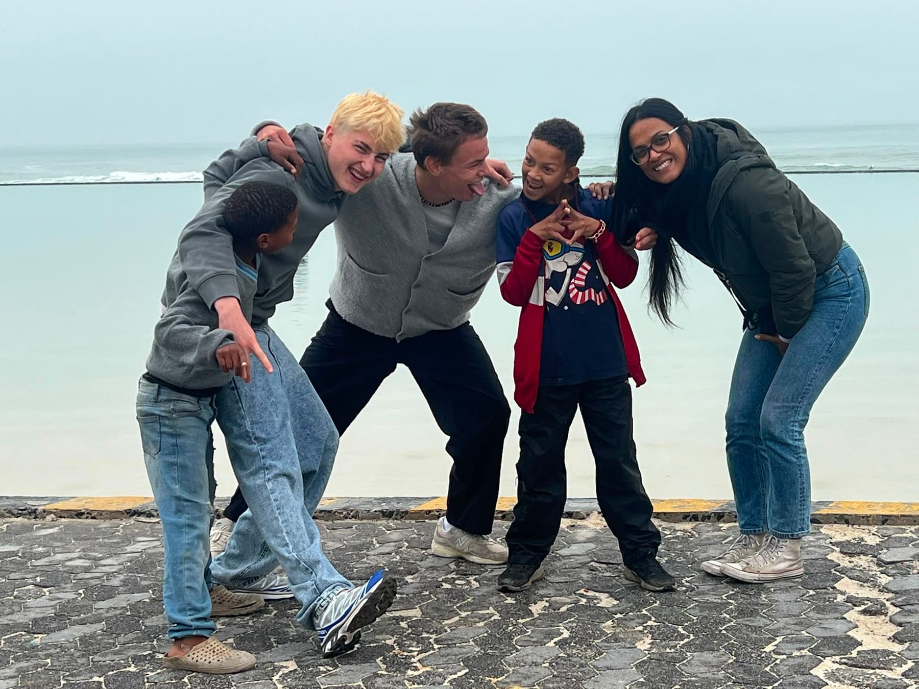 A group leaning in for a photo on the promenade