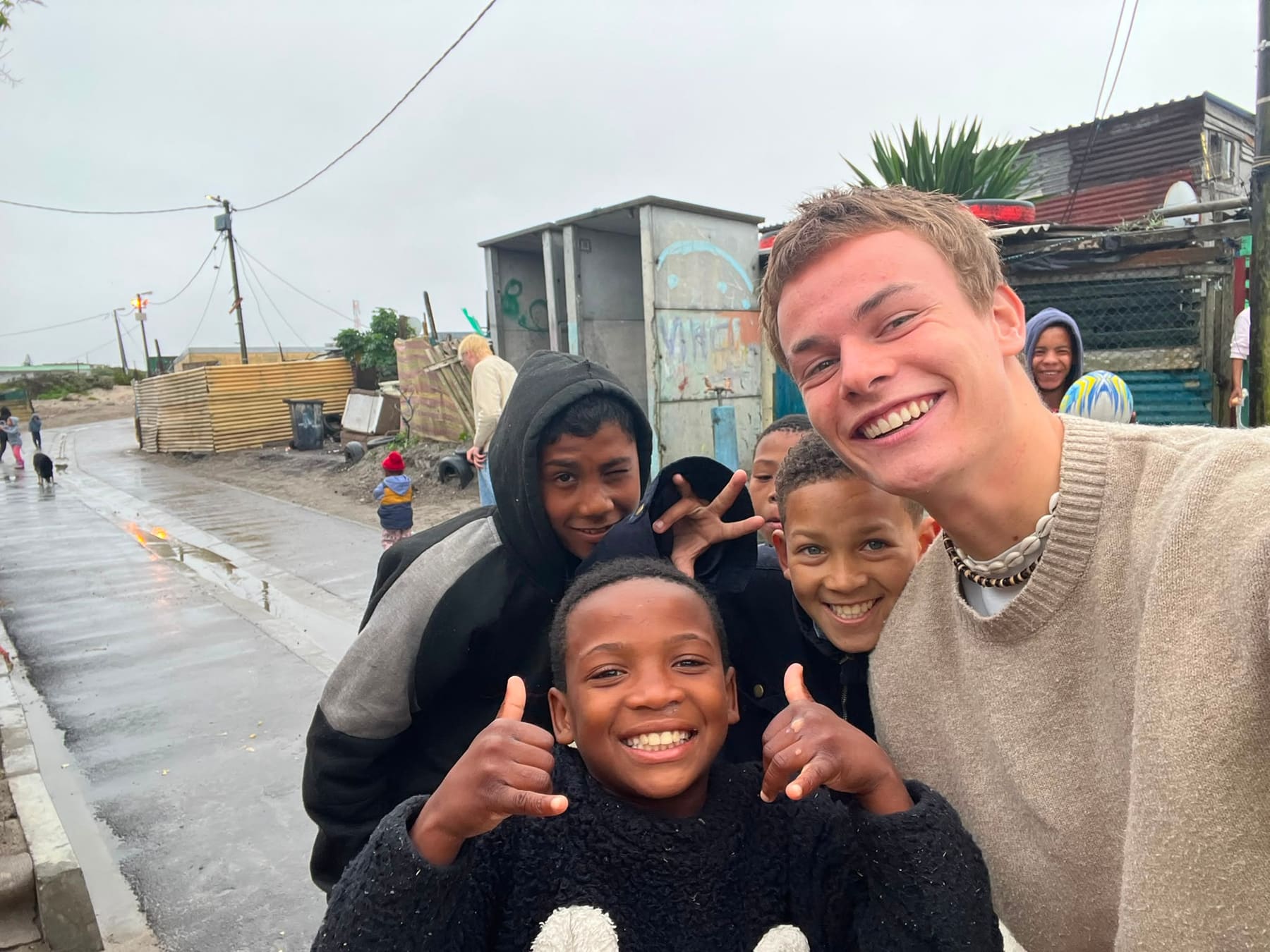 Thumbs up from the kids on a street in the community